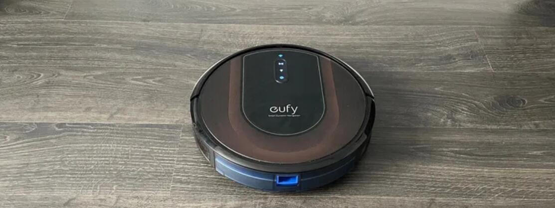Eufy RoboVac G30 Hybrid upside down with the mopping pad attached on a wooden floor