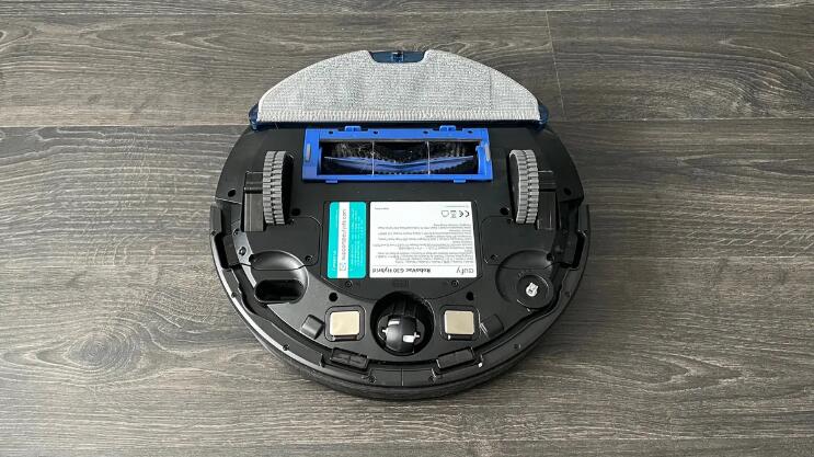 Eufy RoboVac G30 Hybrid upside down with the mopping pad attached on a wooden floor